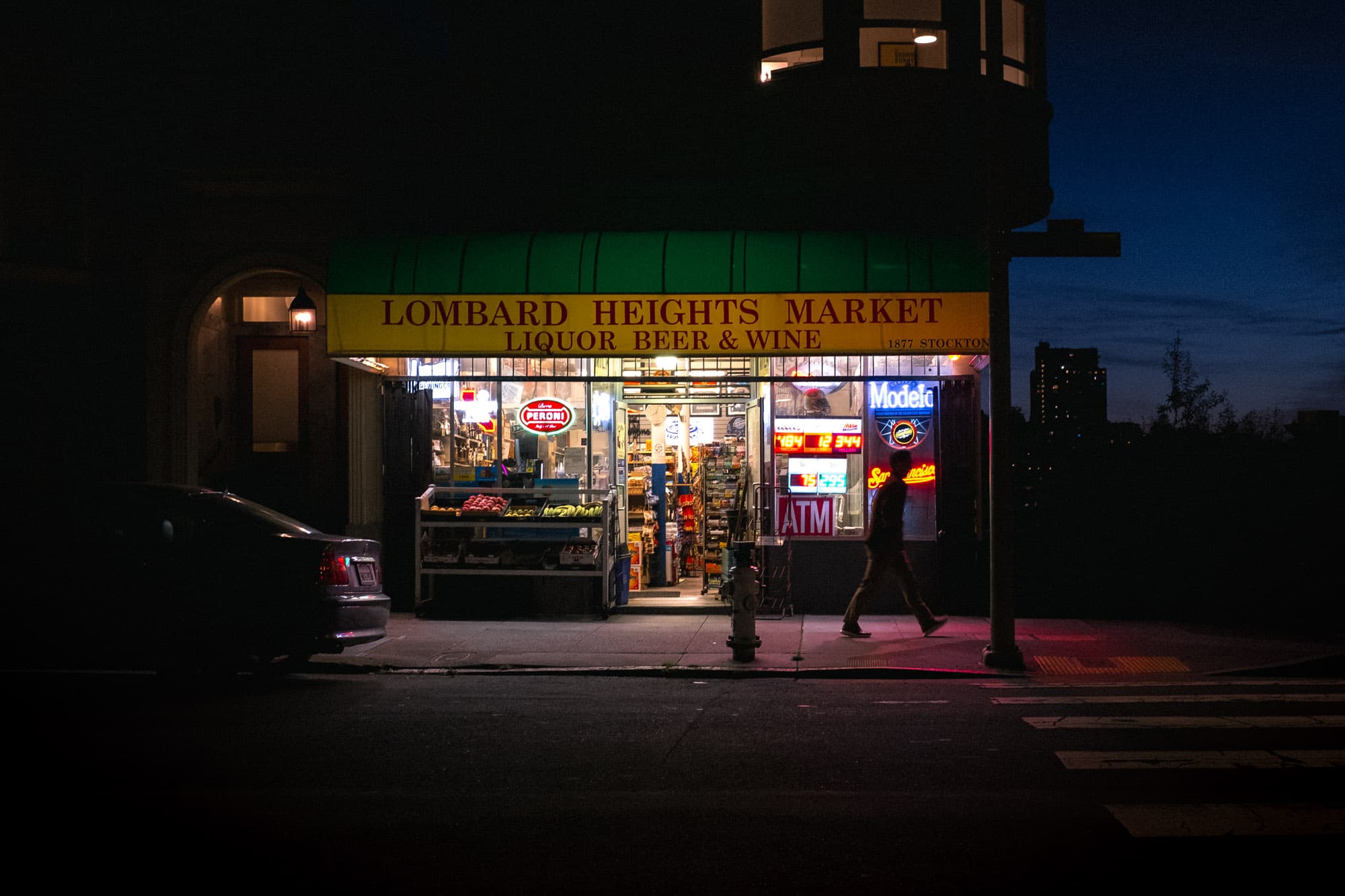 A nighttime look at a brightly lit shop